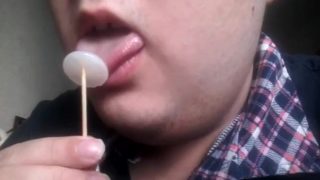 Gay teen licks and eats a lollipop made of his own cum