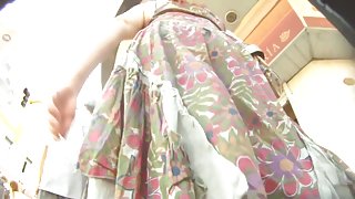 Colorful skirt is moving her ass down the street on the vid