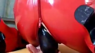 Slut is in latex while fucking her muff with a dildo
