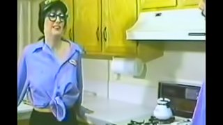 Hot babe with glasses plays with a guy's cock in kitchen