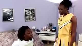 Ebony cheerleader rides a big black cock and gets facialed
