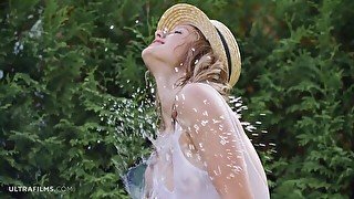 A beautiful naked teen Clarice is having fun with a huge hose