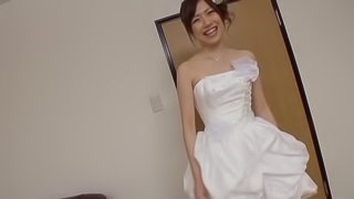 An Asian girl in a wedding dress gets fucked by two guys