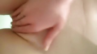 Brunette rubs her pussy in the bathtub and plays with her small tits