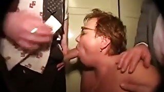 Red curly haired mature hooker works on several cocks at once