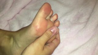 Pink Toed Teen Rubs Glitter Lotion On Feet