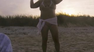 Wow! Sunset Sarong. Nude beach MILF public standing pee. Exposed pussy and sheer covered nipples.