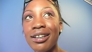 Ebony-skinned cougar with glasses sucking a big white cock through a glory hole
