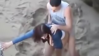 Hot young couple get caught fucking at the beach