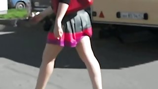 A hot up skirt of a girls ass in red g string