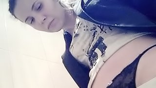 Busty babe with cute face is pissing