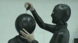 Two Girls In Black Latex Catsuits With Ballhood And Inflateable Mittens