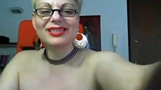 Nerdy blond haired mature slut poses topless for me on webcam
