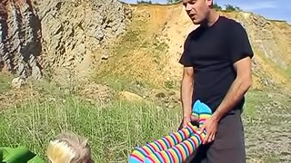 Blonde teen gives footjob in socks and gets anal in the nature