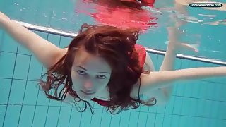 Teen in a pretty red dress slips into the pool