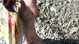 Voyeur tapes a mature couple having sex in public at the beach