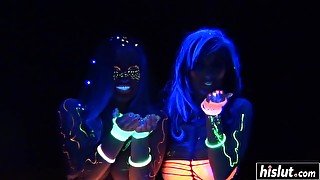 Busty girls are playing with fluorescen paint and a few dildos