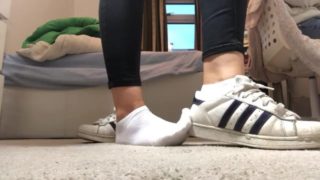 Teen Girl Taking Off Her Shoes to Show her Dirty Socks