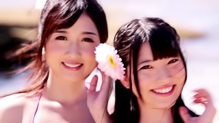 A group of charming Japanese chicks share a boner on a beach