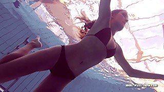 Long haired babe Lucy Gurchenko swimming in a pool