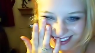 Smiling blonde is sucking a dick on the cam