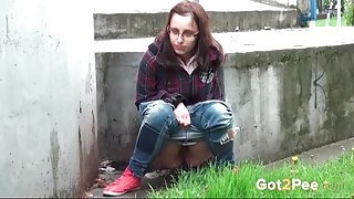 Nerdy girl takes a messy piss outdoors