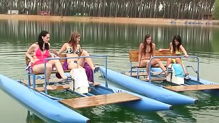 A group of hot, naked lesbians have an orgy on a lake