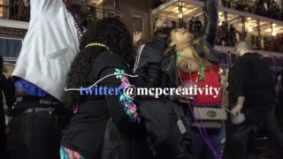 Black chick Flashing one tit for the crowd during mardi gras 2018