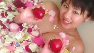 Romantic Asian chick Megumi Kagurazaka takes a bath with rose petals