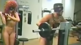 Strange couple hit the gym together then fuck with a strap on in POV