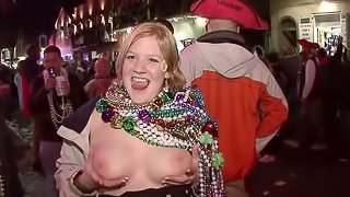 These wild girls whip their tits out in public during a street party