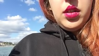 Sexy Redhead Teen in Black with Long Hair Smoking on the Beach in England