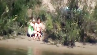 Voyeur tapes a couple having sex in public on the side of the river