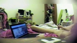 Horny young babe watches porn and masturbates on hidden cam