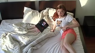 Brown-haired babe masturbates next to her laptop