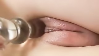 Young slim blonde babe with blue eyes drills her wet puffy pussy with a glass dildo