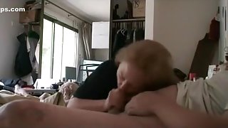 Brunette milf gives her fat nerdy glassed husband a blowjob with cum swallowing on the bed