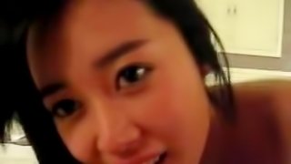 Cute Asian girlfriend sucking and licking on a white hard cock
