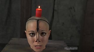 Candle drips wax on the head of a bound girl