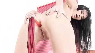 black haired slut jams a whip in her tight butthole