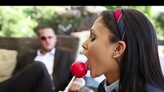 Cute schoolgirl is sucking a nice candy