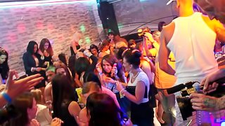 Horny whores stripping naked in a packed club and having an orgy