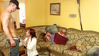 Redhead Nikki Hunter gets fucked by a younger guy on a sofa
