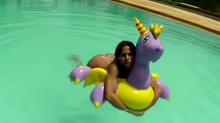 Latina bikini tranny floating in the pool and jerking off