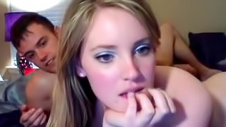 Cute girlfriend is kissing with her boy in the bedroom