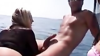 Horny blond and black-haired babes in white mini-skirt and black-leather thong get pussies pleasured on boat