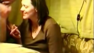 A chubby brunette milf giving some guy head without any idea she is being filmed.