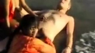 2 Indian girls with white guy in beach have fun blowjob..