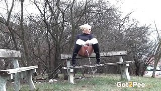 Chick in a turtleneck takes a piss in public