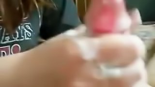 Girl rubs her boyfriend's cock till the guy cums to her hands